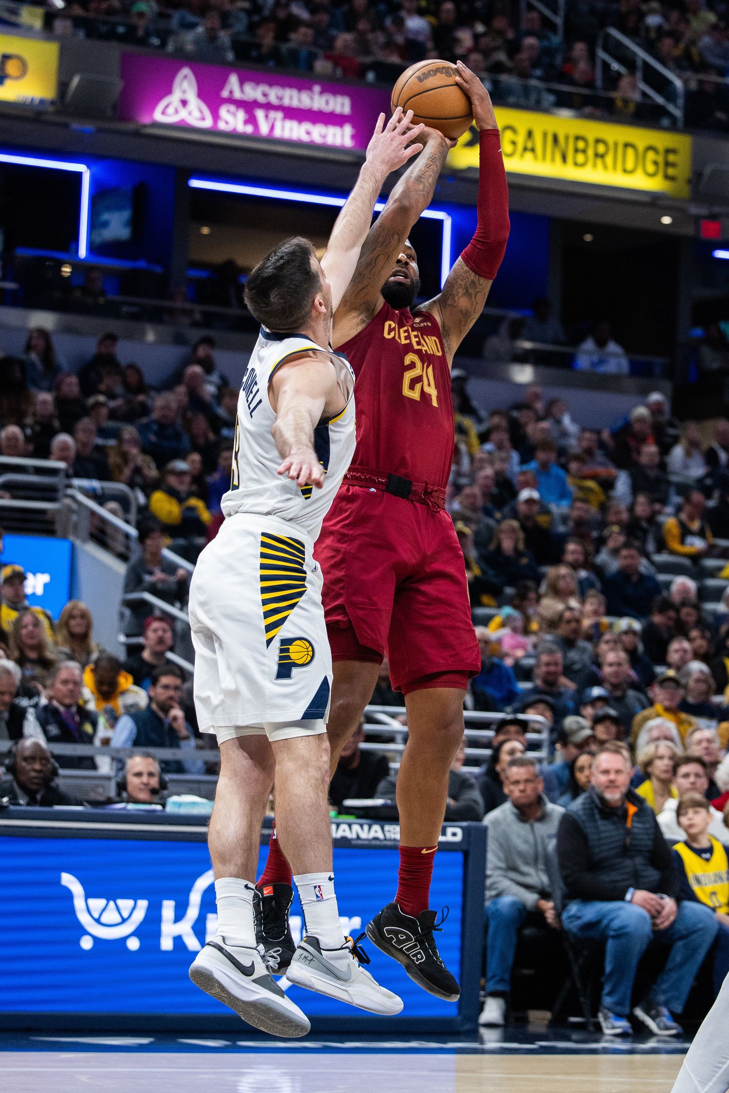 Mar 18, 2024; Indianapolis, Indiana, USA; Cleveland Cavaliers forward Marcus Morris Sr (24) shoots the ball while Indiana Pacers guard T.J. McConnell (9) defends in the second half at Gainbridge Fieldhouse. Mandatory Credit: Trevor Ruszkowski-USA TODAY Sports