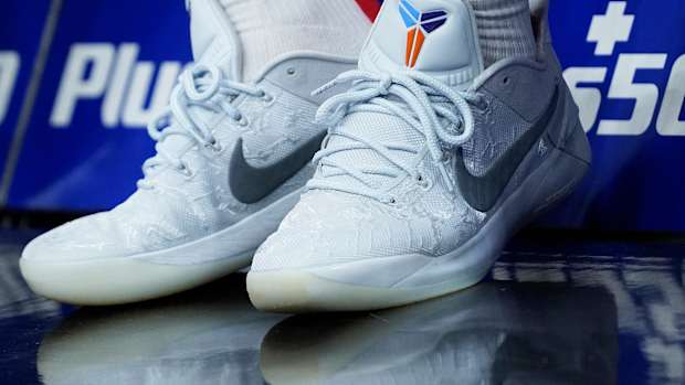 View of white and grey Nike Kobe shoes.