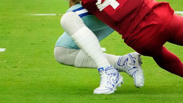 Arizona Cardinals linebacker Dennis Gardeck tackles Dallas Cowboys quarterback Dak Prescott.