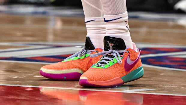 View of orange and green Nike LeBron shoes.