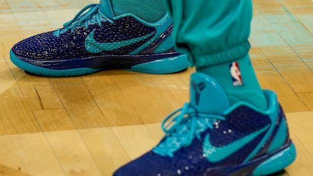 Charlotte Hornets guard Terry Rozier's teal and navy Nike Kobe sneakers.