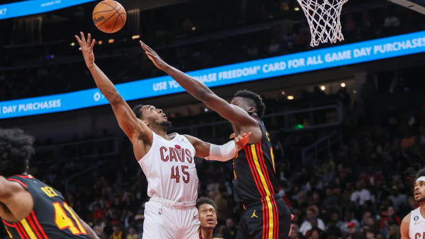Feb 24, 2023; Atlanta, Georgia, USA; Cleveland Cavaliers guard Donovan Mitchell (45) shoots over Atlanta Hawks center Clint Capela (15) in the first quarter at State Farm Arena. Mandatory Credit: Brett Davis-USA TODAY Sports