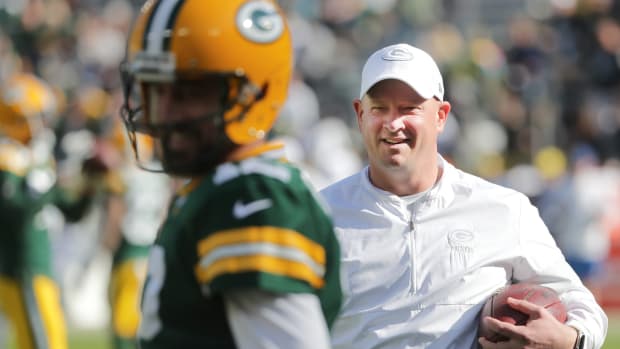 Green Bay Packers offensive coordinator Nathaniel Hackett talks with quarterback Aaron Rodgers (12) before their game against the Oakland Raiders Sunday, October 21, 2019 at Lambeau Field in Green Bay, Wis.