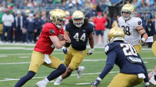 Notre Dame quarterback Sam Hartman runs with the ball.