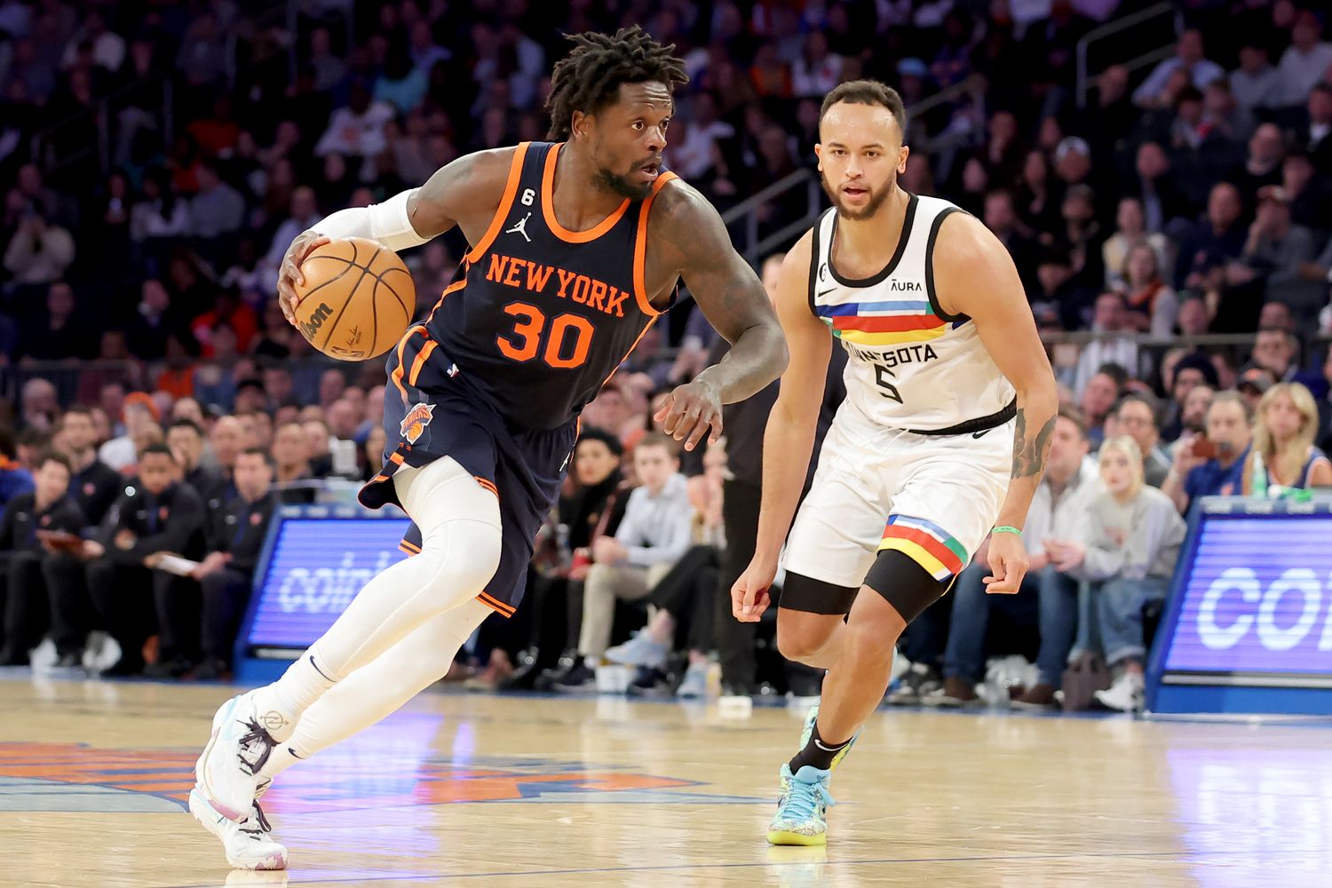 New York Knicks forward Julius Randle dribbles past Minnesota Timberwolves forward Kyle Anderson.