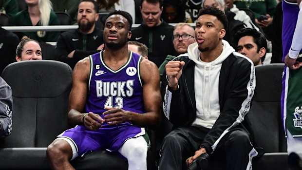 Apr 7, 2023; Milwaukee, Wisconsin, USA; Milwaukee Bucks forward Giannis Antetokounmpo sits with his brother forward Thanasis Antetokounmpo