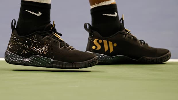 View of Serena Williams' black and gold Nike shoes.