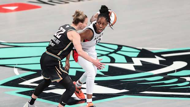 Las Vegas Aces guard Chelsea Gray dribbles past New York Liberty guard Courtney Vandersloot.