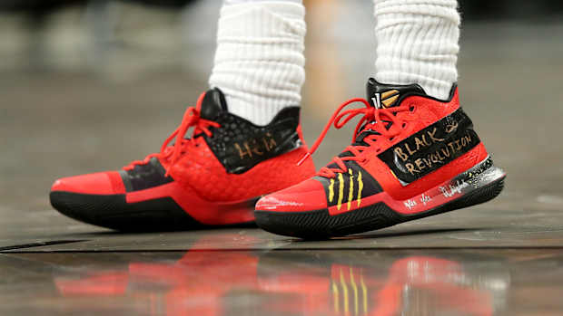 View of Kyrie Irving's red and black Nike shoes.