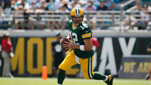 Green Bay Packers quarterback Aaron Rodgers runs with the ball.