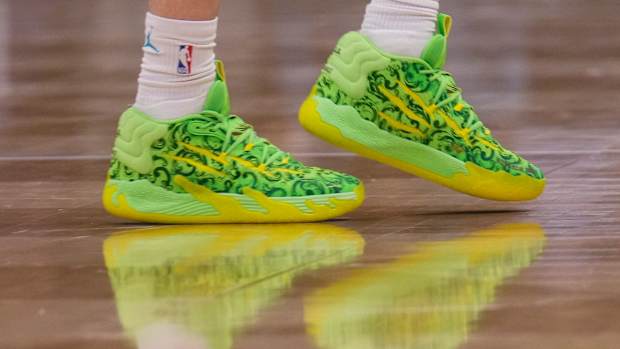 Charlotte Hornets guard LaMelo Ball's green and yellow PUMA shoes.