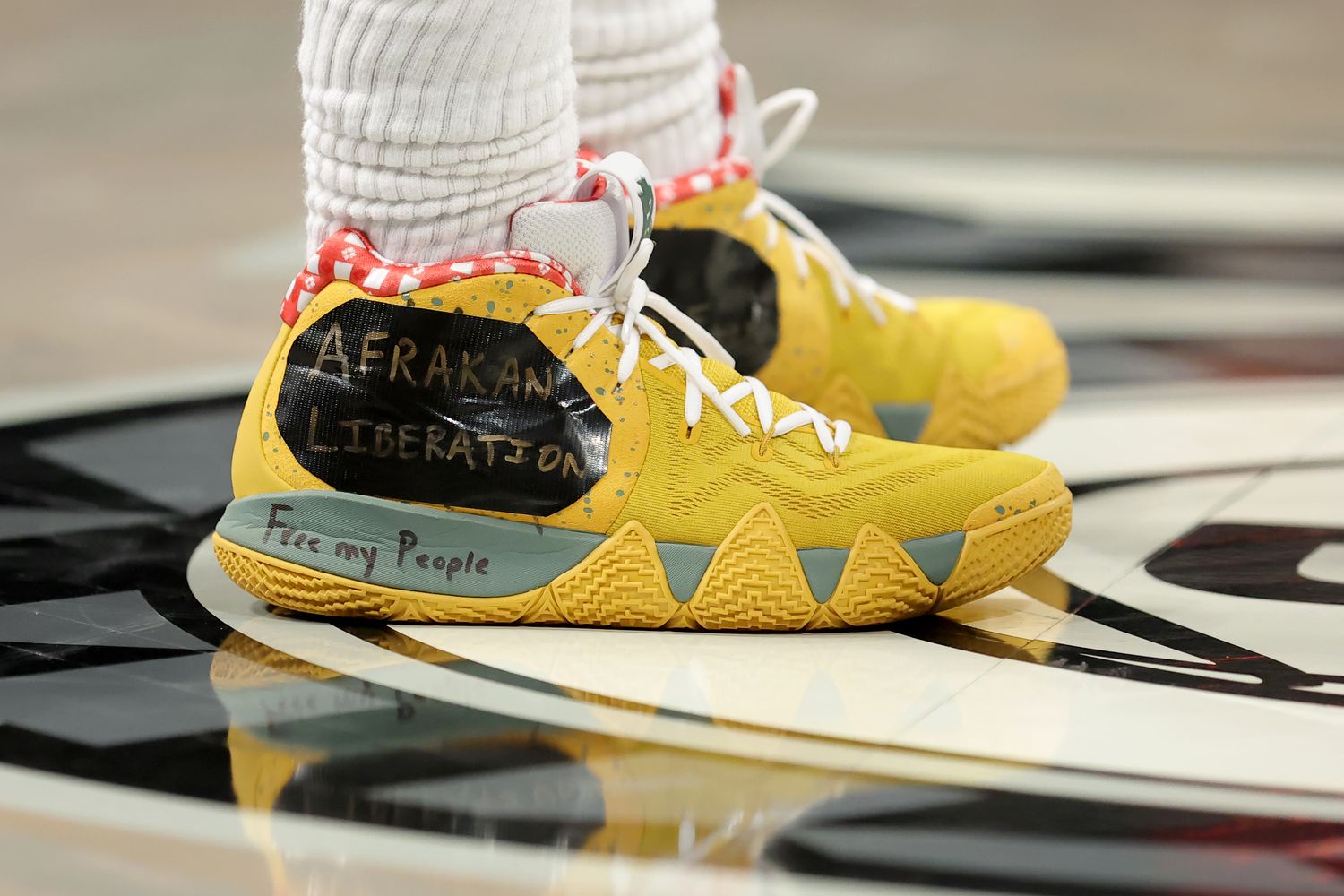 View of Kyrie Irving's yellow Nike shoes.