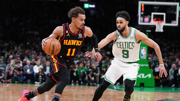 Atlanta Hawks guard Trae Young dribbles past Boston Celtics guard Derrick White.