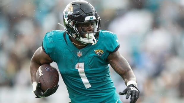 Jaguars running back Travis Etienne runs with the ball in a game vs. the Las Vegas Raiders.