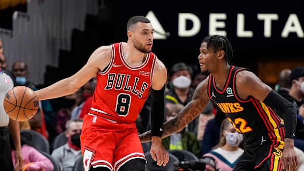 Dec 27, 2021; Atlanta, Georgia, USA; Chicago Bulls guard Zach LaVine (8) controls the ball in front of Atlanta Hawks forward Cam Reddish (22) during the first half at State Farm Arena.
