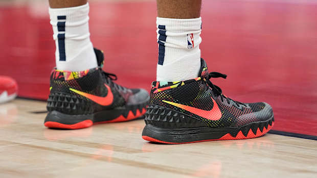View of black and red Nike Kyrie shoes.