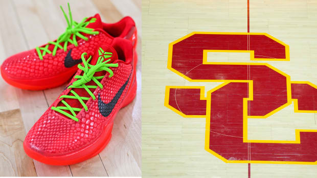 Kobe Bryant's red and green Nike sneakers on the USC Trojans basketball court.