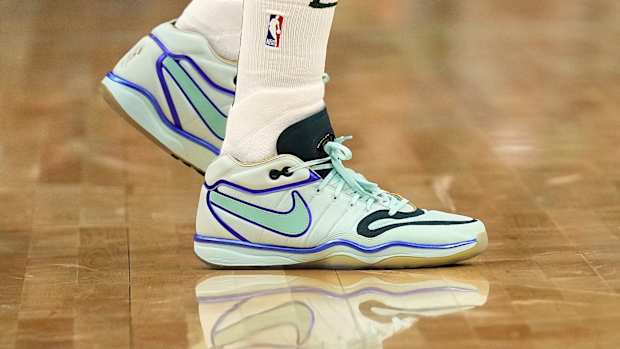 Milwaukee Bucks forward Khris Middleton's teal and black Nike sneakers.