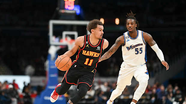 Atlanta Hawks guard Trae Young dribbles past Washington Wizards guard Delon Wright.