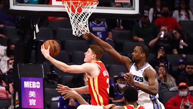 Jan 5, 2022; Sacramento, California, USA; Atlanta Hawks guard Kevin Huerter (3) scores a basket against Sacramento Kings forward Harrison Barnes (40) during the fourth quarter at Golden 1 Center.