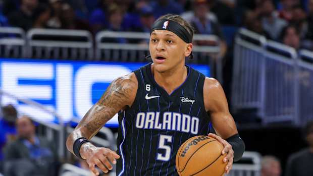 Orlando Magic forward Paolo Banchero dribbles the ball.