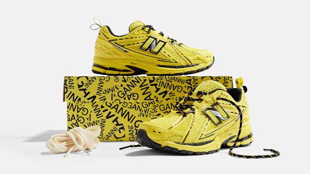 Side view of yellow and black New Balance shoes.