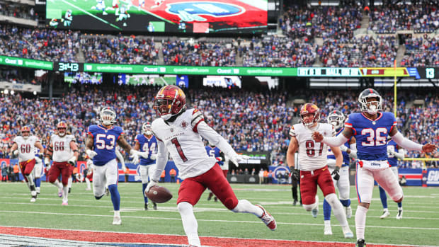 Washington Commanders receiver Jahan Dotson (1) scores against the New York Giants.