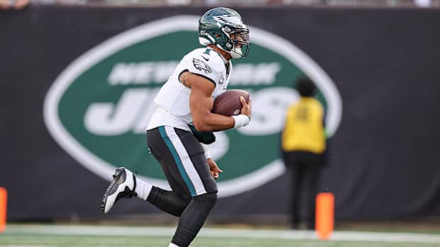 Philadelphia Eagles quarterback Jalen Hurts runs with the football.