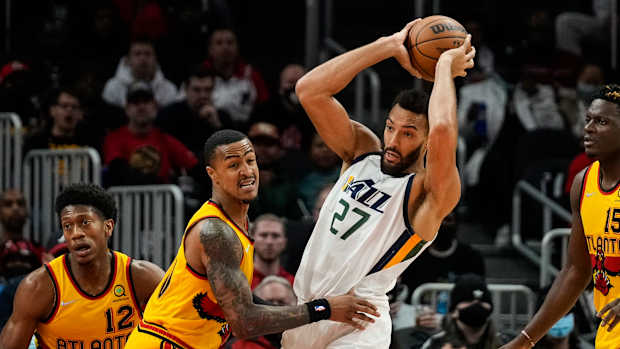 Rudy Gobert controls the ball against John Collins.