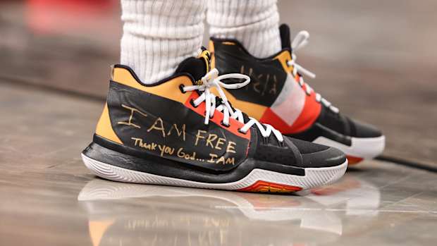 View of Kyrie Irving's black and yellow shoes.