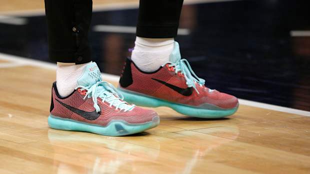 View of red and teal Nike Kobe shoes.