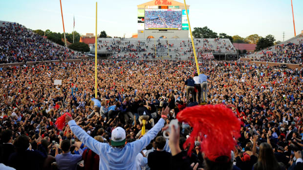 Ole Miss fans celebrate their 2014 win over Alabama by storming the field at Vaught-Hemingway Stadium and tearing down the goal posts.