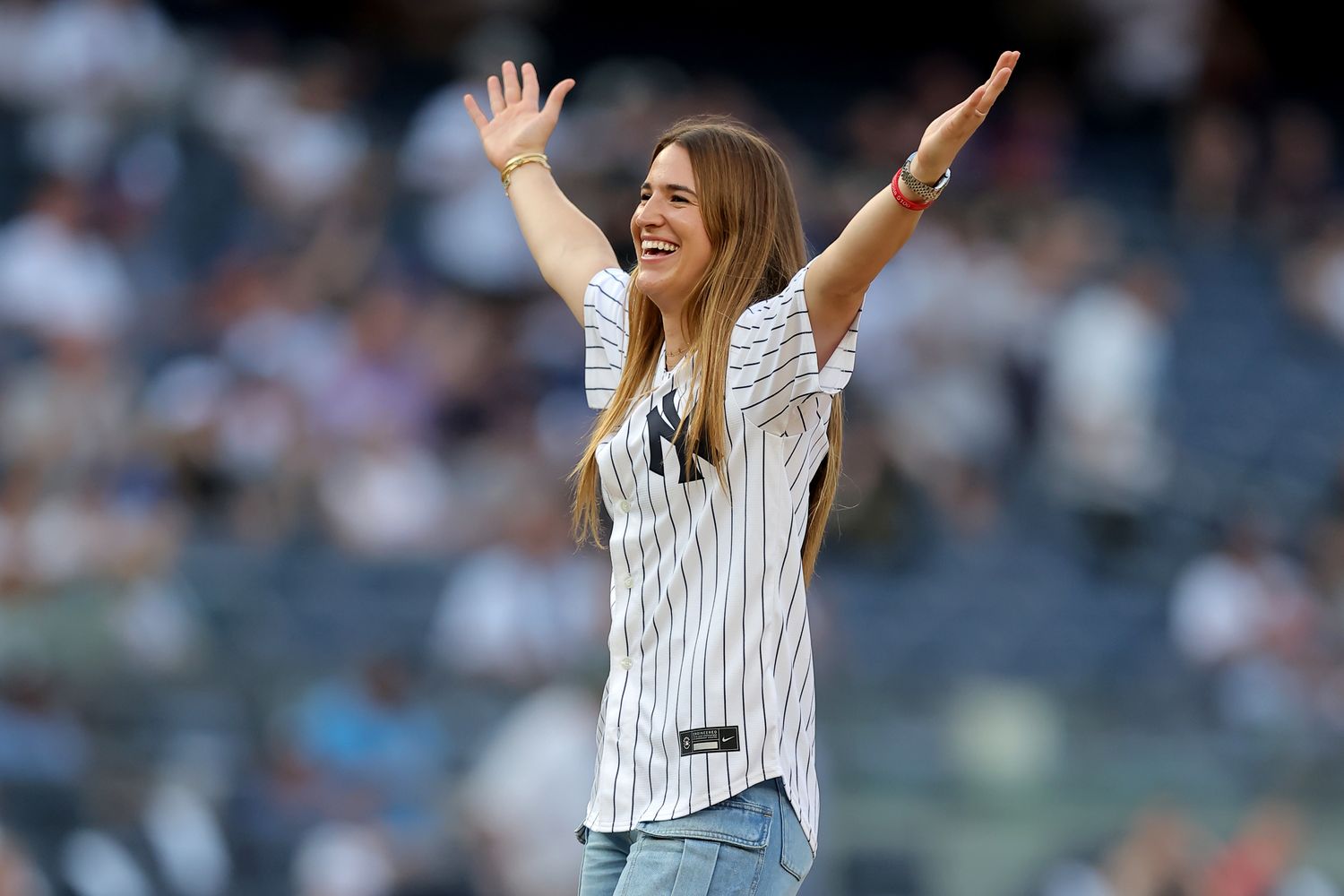 Sabrina Ionescu reacts after throwing out a ceremonial first pitch at a New York Yankees game.