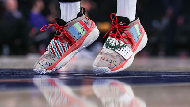 Milwaukee Bucks guard Damian Lillard's white, red, and black adidas sneakers.