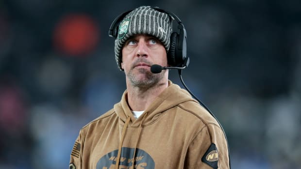 New York Jets injured quarterback Aaron Rodgers looks on during a game.
