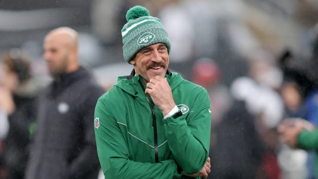 New York Jets quarterback Aaron Rodgers looks on from the sideline.