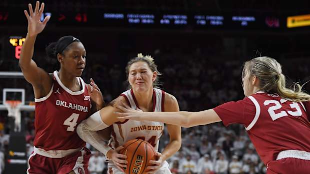 Iowa State Cyclones guard Ashley Joens (24) drives to the basket between Oklahoma Sooners guard Kennady Tucker (4) and Oklahoma Sooners guard/forward Skylar Vann (24) during the third quarter at Hilton Coliseum, Saturday, Feb. 19, 2022, in Ames, Iowa.