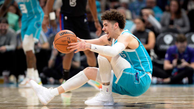 Charlotte Hornets guard LaMelo Ball falls down during a game.