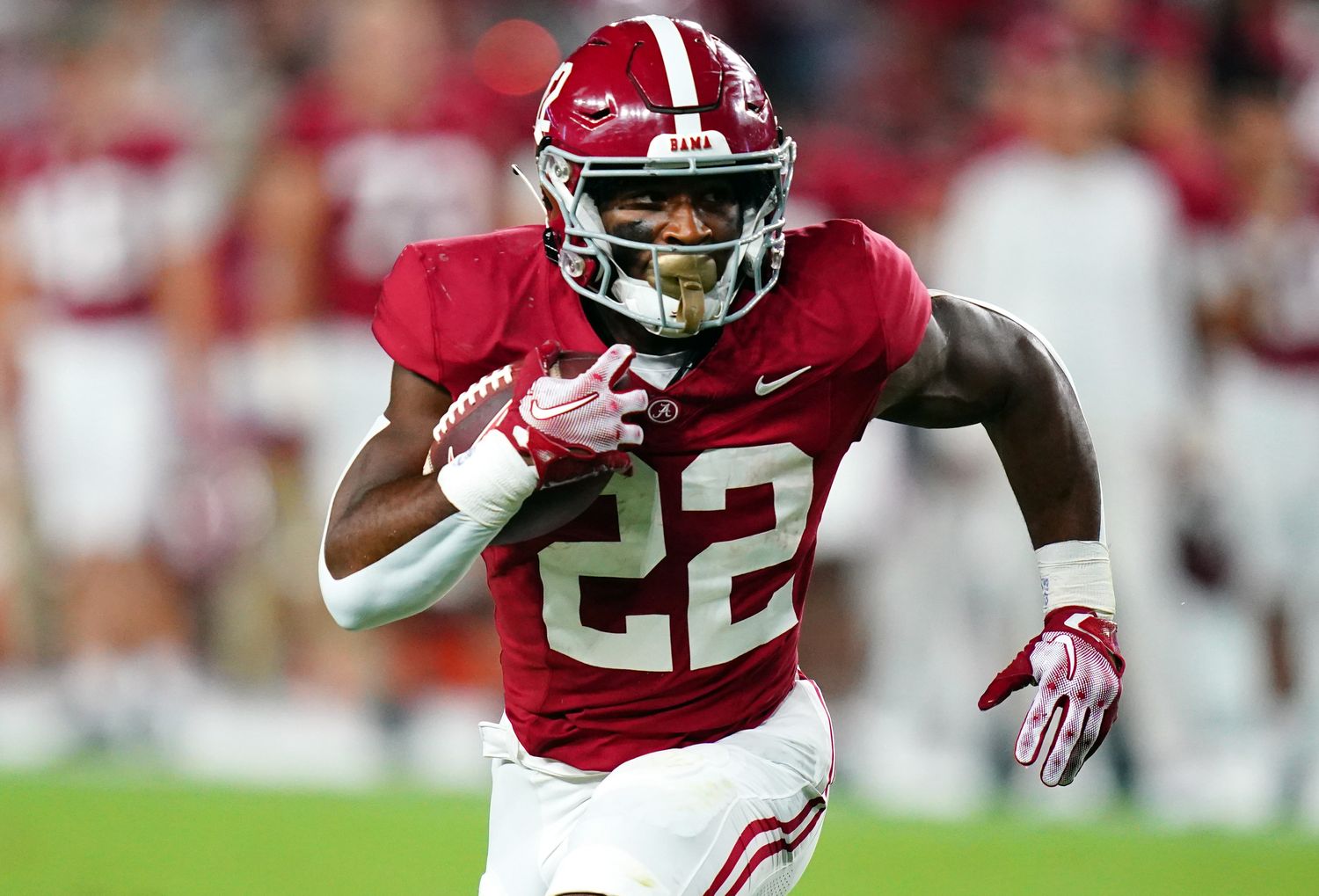 Alabama Crimson Tide running back Justice Haynes on a rushing attempt during a college football game.