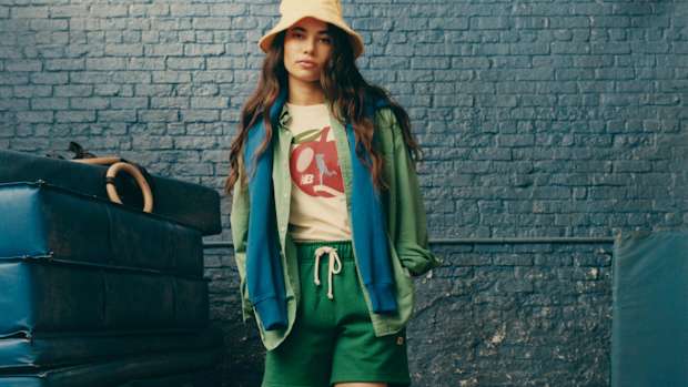 Female model poses in New Balance clothing.