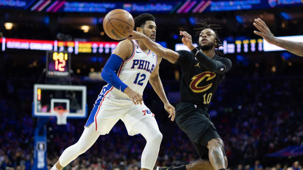 Cleveland Cavaliers guard Darius Garland (10) passes the ball past Philadelphia 76ers forward Tobias Harris (12) during the first quarter at Wells Fargo Center.