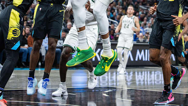Milwaukee Bucks forward Giannis Antetokounmpo's green and yellow Nike sneakers.