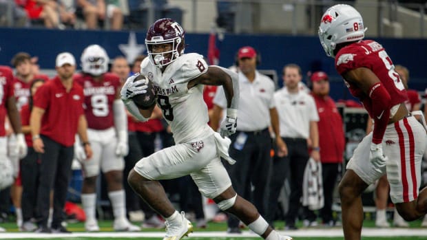 Texas A&M Aggies running back Le'Veon Moss (8) and Arkansas Razorbacks defensive back Jayden Johnson (8) In action during the game between the Texas A&M Aggies and the Arkansas Razorbacks at AT&T Stadium