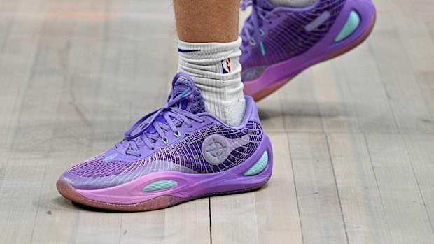 Los Angeles Lakers guard Austin Reaves' purple and teal sneakers.