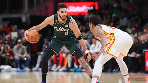 Atlanta Hawks forward De'Andre Hunter defends Boston Celtics forward Jayson Tatum.