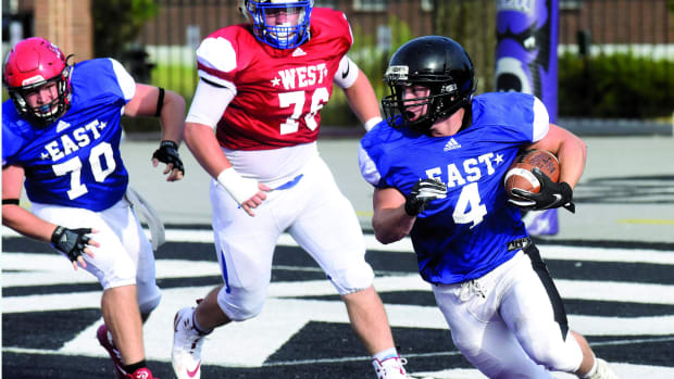 Salem's Jordan Turner carries for the East in the Arkansas High School Coaches Association's All-Star football game at Estes Stadium in Conway.