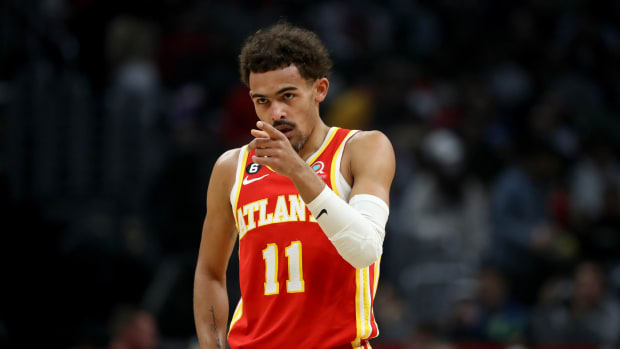 Atlanta Hawks guard Trae Young points to a teammate during a game.