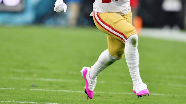 View of San Francisco 49ers wide receiver Deebo Samuel's white and pink Air Jordan cleats.