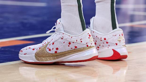 Milwaukee Bucks forward Giannis Antetokounmpo's white, red, and gold Nike sneakers.
