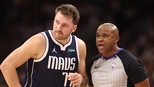 Dallas Mavericks superstar Luka Doncic talking with an official.